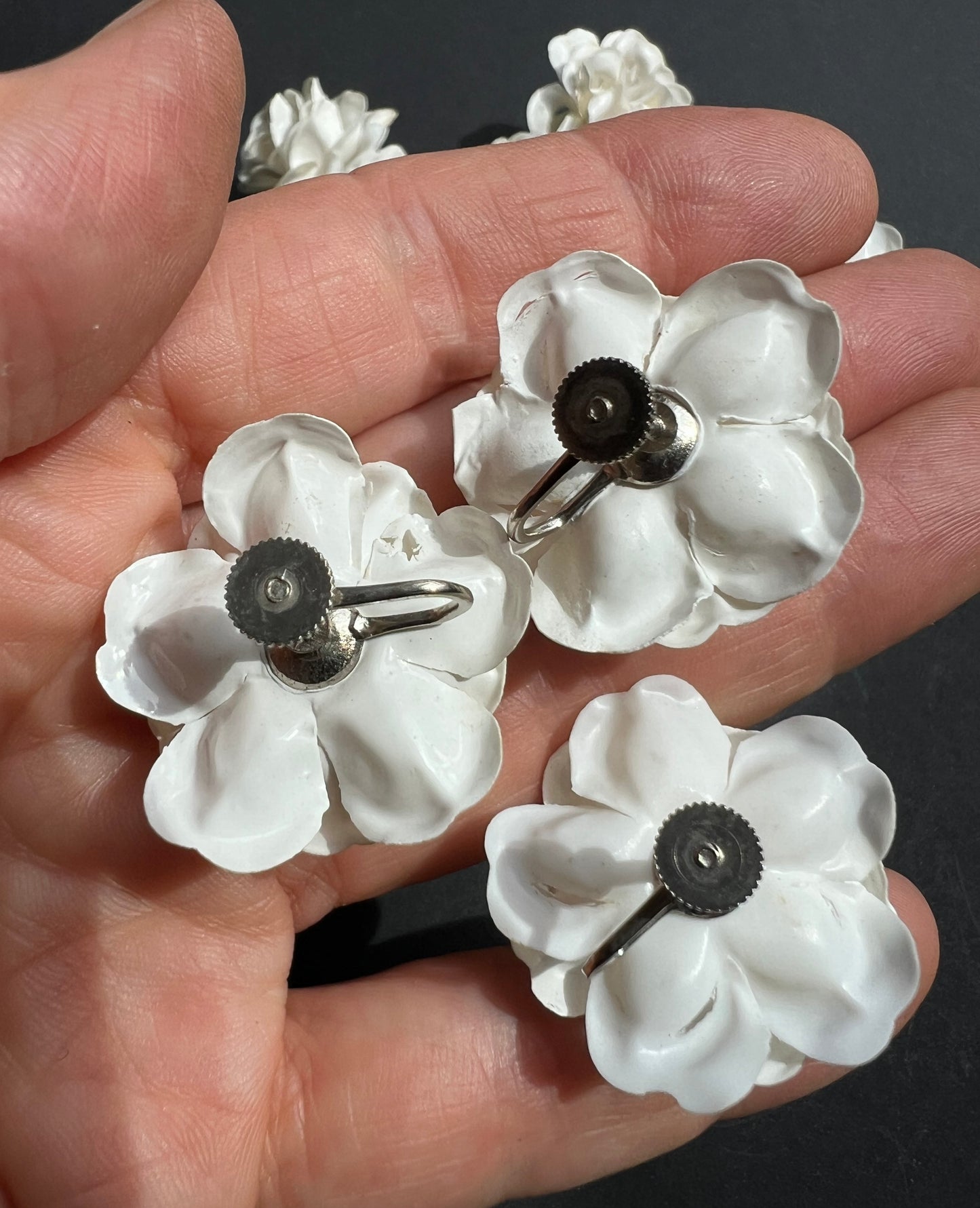 11 Pairs of Vintage White Celluloid Flower Screw On Earrings - with slight splits underneath.