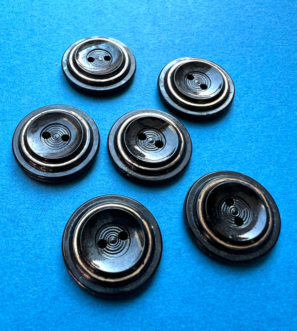 5 or 6 Early C20th Black + Gold Glass 2.2cm Buttons