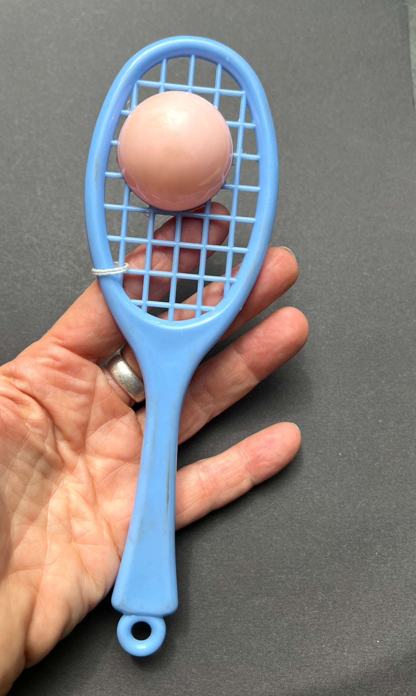 A Vintage Rattle that is a Tennis Racquet and Ball