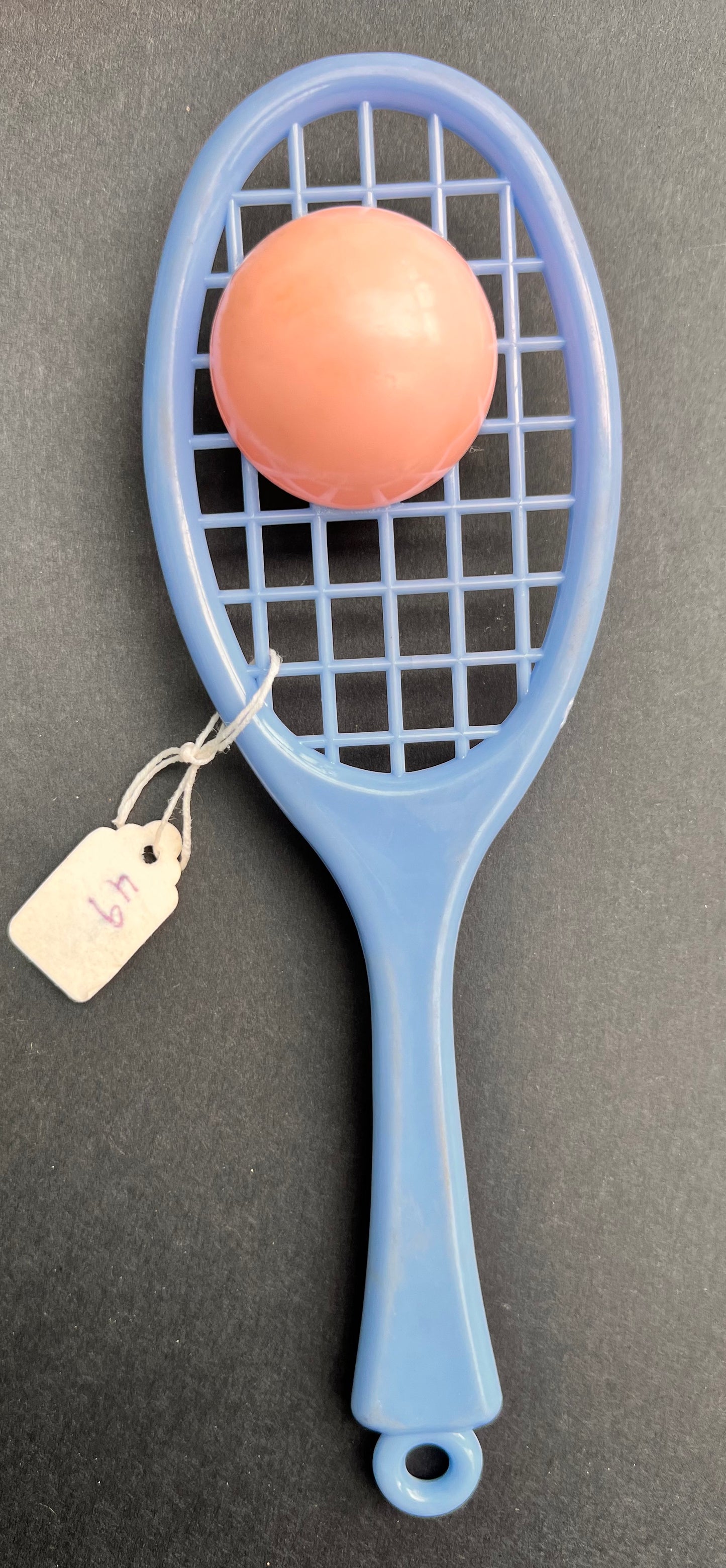 A Vintage Rattle that is a Tennis Racquet and Ball