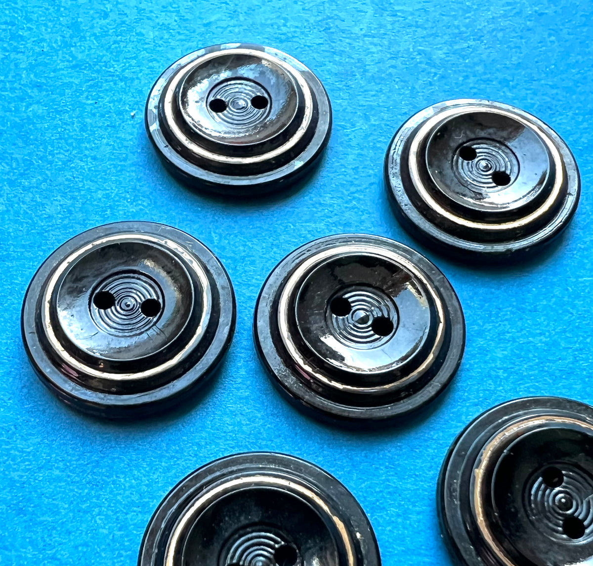 5 or 6  Early C20th Black + Gold Glass 2.2cm Buttons