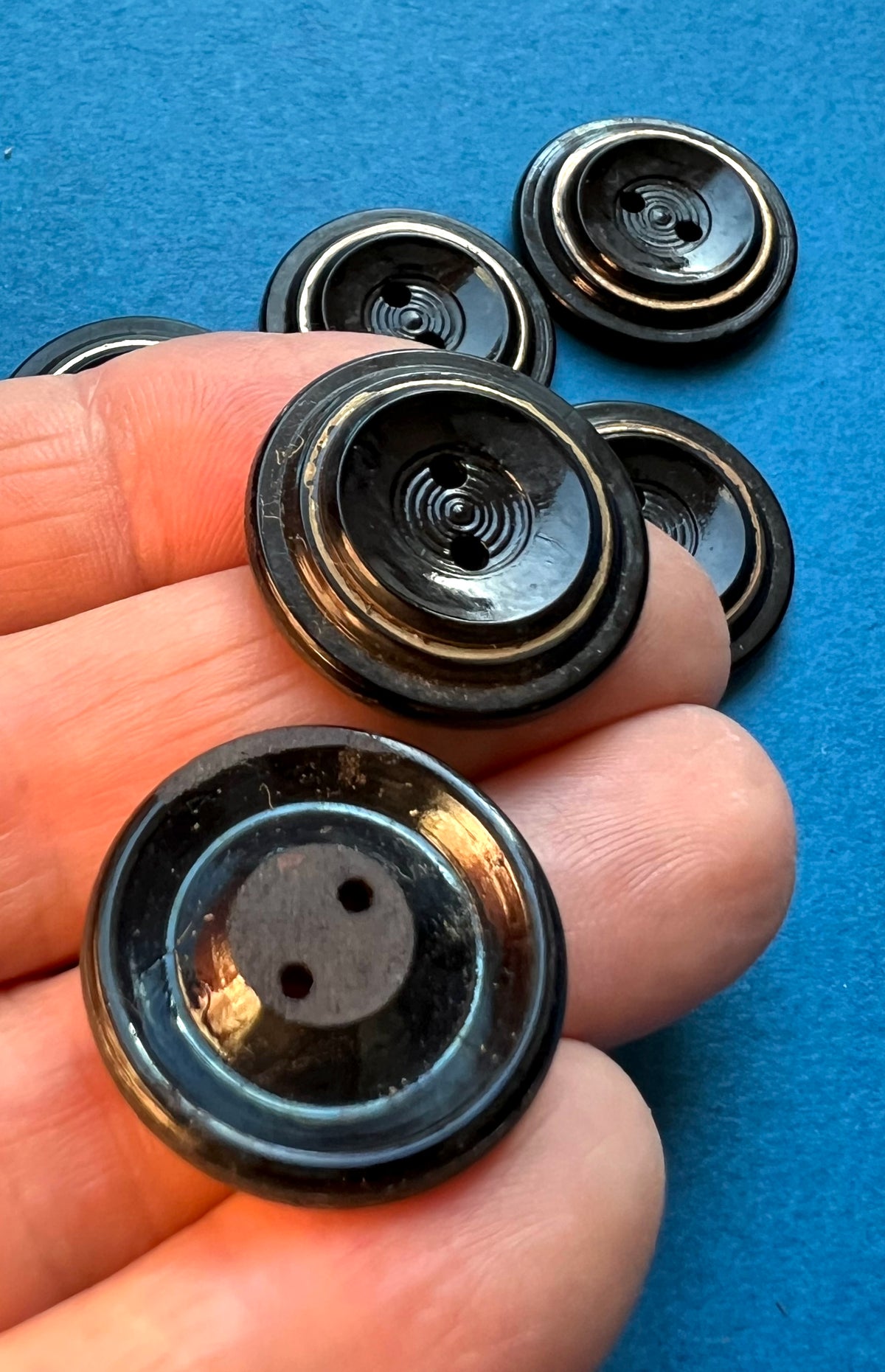5 or 6  Early C20th Black + Gold Glass 2.2cm Buttons