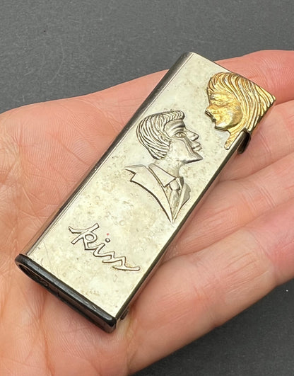 Vintage Novelty Lighter - the couple KISS when you press the lighter down !