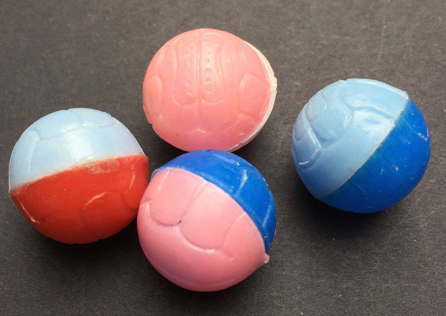 4 Little Plastic Football Balls...1.5cm wide.